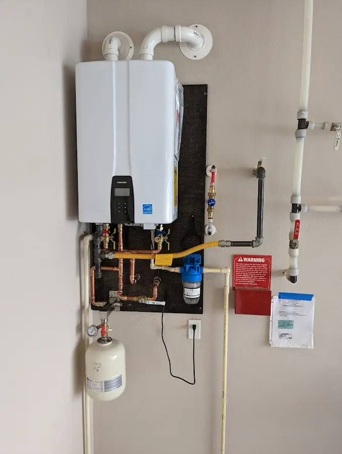 Professional plumber installing copper piping in a Summersville home